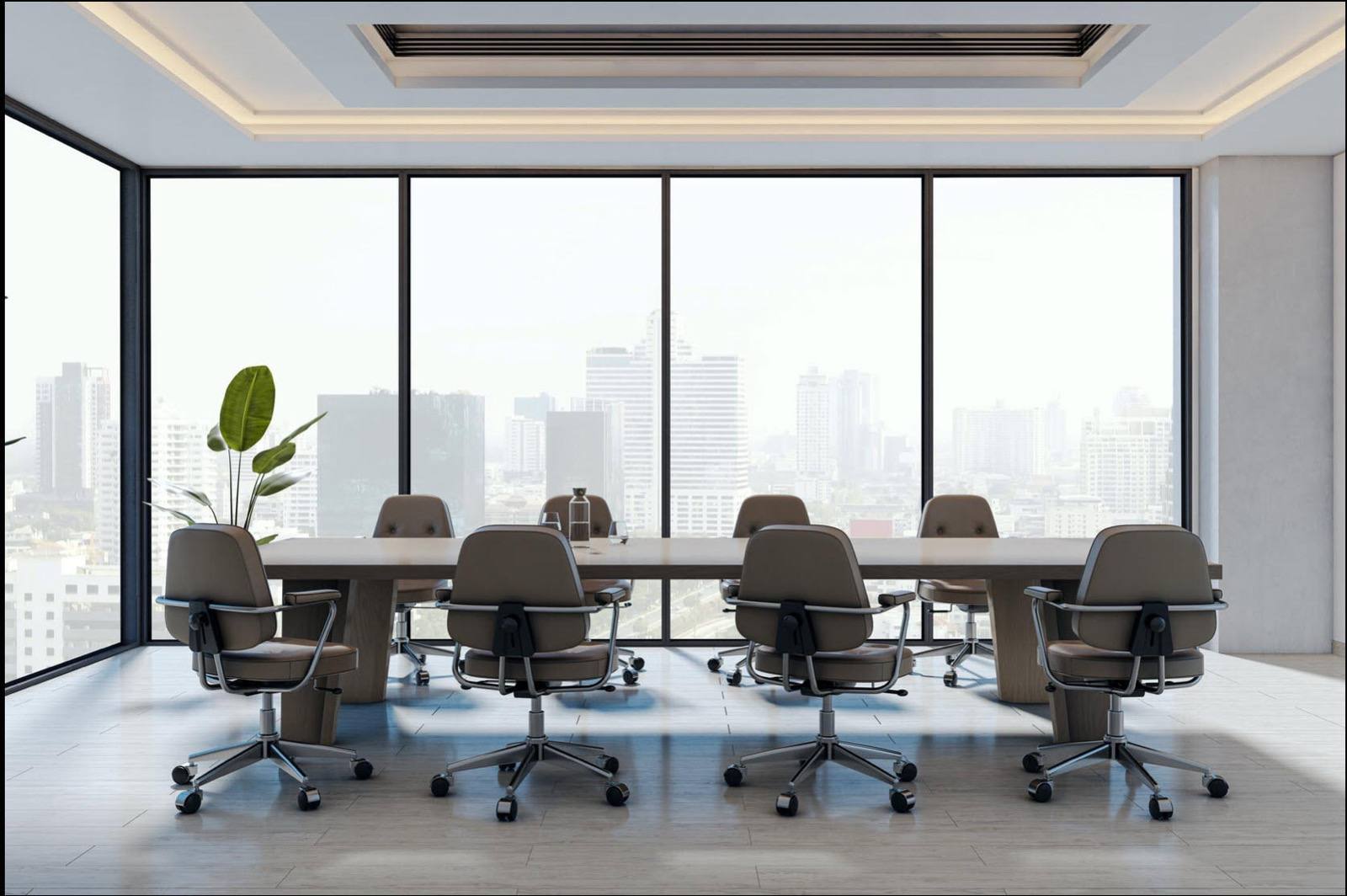 Executive boardroom with a long table and a city skyline through the windows